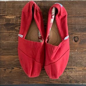Red TOMS slip ons